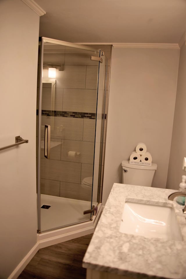 632 E 5th Ave, Lancaster, OH 43130 - bathroom featuring toilet, a stall shower, crown molding, wood finished floors, and vanity