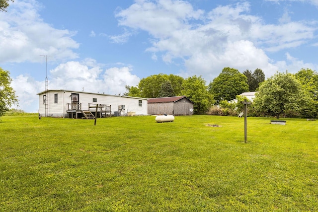 11095 High Point Rd, Thornville, OH 43076 - view of green lawn with a deck and an outbuilding