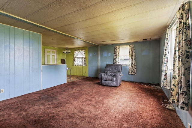 11095 High Point Rd, Thornville, OH 43076 - unfurnished room featuring carpet flooring, a chandelier, and wood walls
