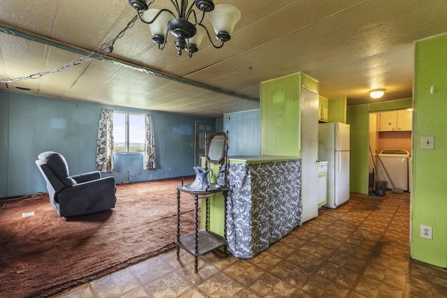 11095 High Point Rd, Thornville, OH 43076 - kitchen with freestanding refrigerator, washer / clothes dryer, and a chandelier
