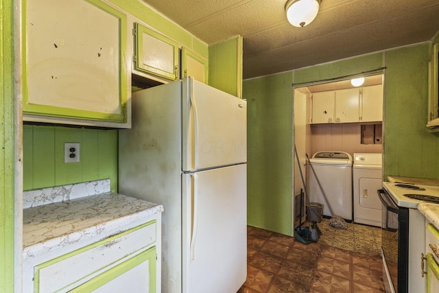 11095 High Point Rd, Thornville, OH 43076 - kitchen with separate washer and dryer, freestanding refrigerator, range with electric cooktop, dark flooring, and light countertops