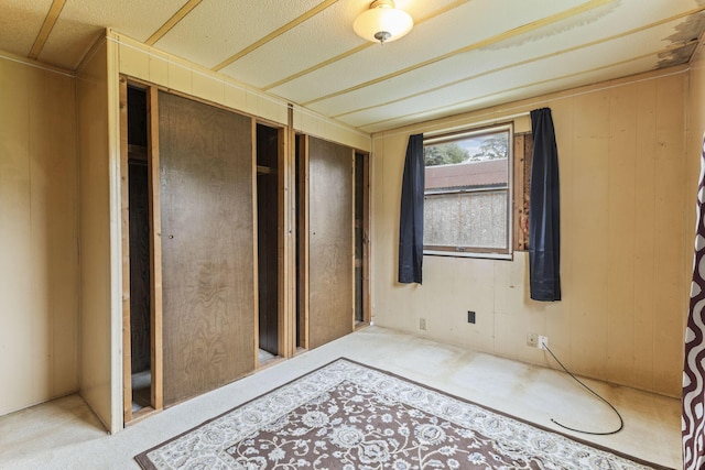 11095 High Point Rd, Thornville, OH 43076 - unfurnished bedroom featuring a closet, wood walls, and carpet