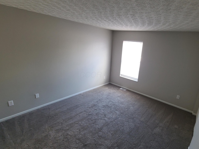 6768 Axtel Dr Unit 15B, Canal Winchester, OH 43110 - spare room featuring a textured ceiling, baseboards, and dark carpet