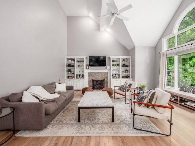 2655 Aikin Cir S, Lewis Center, OH 43035 - living room with a brick fireplace, wood finished floors, ceiling fan, and high vaulted ceiling