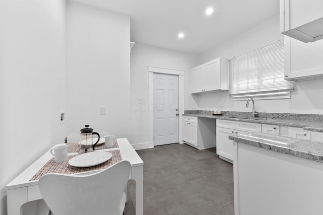 429 S Champion Ave, Columbus, OH 43205 - kitchen with a sink, white cabinetry, light stone countertops, and recessed lighting