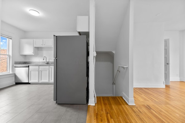 429 S Champion Ave, Columbus, OH 43205 - kitchen featuring appliances with stainless steel finishes, white cabinetry, a sink, and light countertops