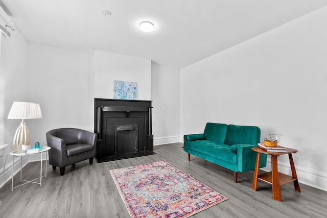 429 S Champion Ave, Columbus, OH 43205 - living area featuring wood finished floors, baseboards, and a fireplace with flush hearth