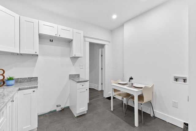 429 S Champion Ave, Columbus, OH 43205 - kitchen featuring white cabinets, baseboards, light stone countertops, tile patterned floors, and recessed lighting