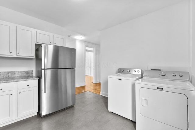 429 S Champion Ave, Columbus, OH 43205 - laundry room featuring washing machine and dryer, light tile patterned floors, and baseboards