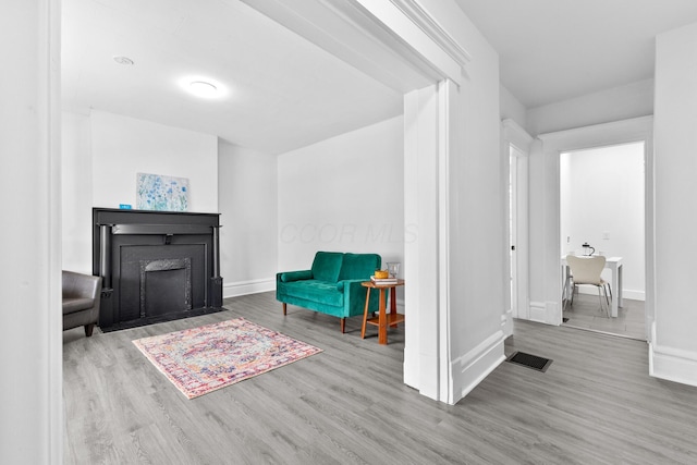 429 S Champion Ave, Columbus, OH 43205 - living area featuring wood finished floors, baseboards, and a fireplace with flush hearth
