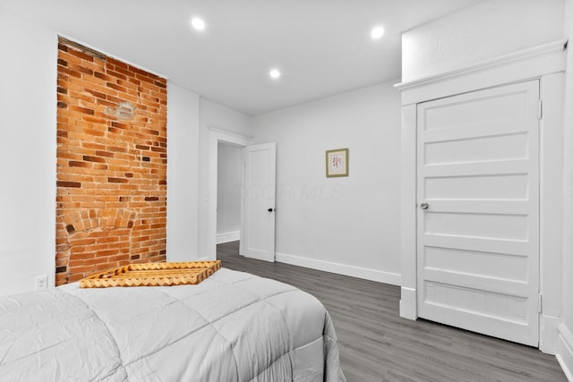 429 S Champion Ave, Columbus, OH 43205 - bedroom with wood finished floors, baseboards, recessed lighting, a closet, and brick wall