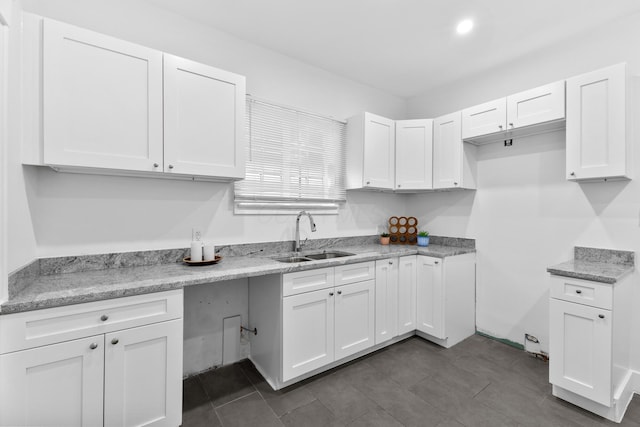 429 S Champion Ave, Columbus, OH 43205 - kitchen featuring a sink, white cabinets, and light stone counters
