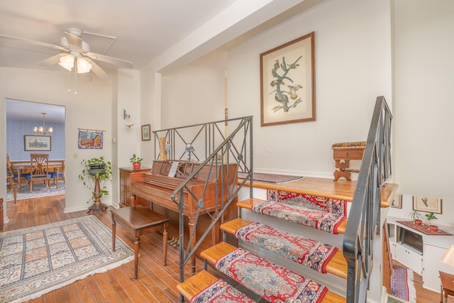 213 Kokosing Dr, Gambier, OH 43022 - stairs with wood-type flooring, a chandelier, and ceiling fan