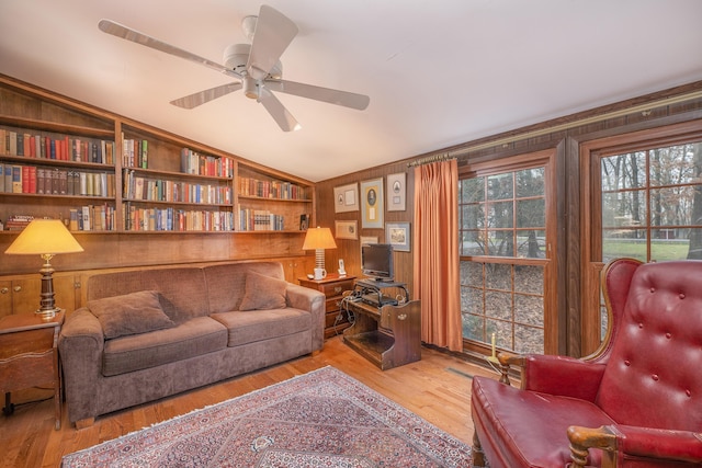 213 Kokosing Dr, Gambier, OH 43022 - living room featuring lofted ceiling, wood finished floors, a ceiling fan, wood walls, and built in features