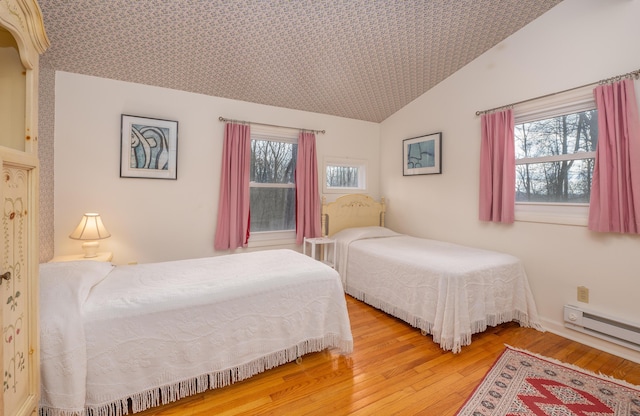 213 Kokosing Dr, Gambier, OH 43022 - bedroom with wood finished floors, vaulted ceiling, and baseboard heating