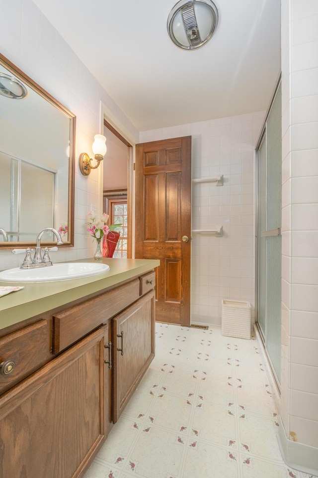 213 Kokosing Dr, Gambier, OH 43022 - bathroom with vanity, tile walls, and a stall shower