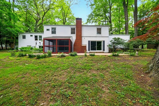 213 Kokosing Dr, Gambier, OH 43022 - back of property featuring a sunroom and a chimney