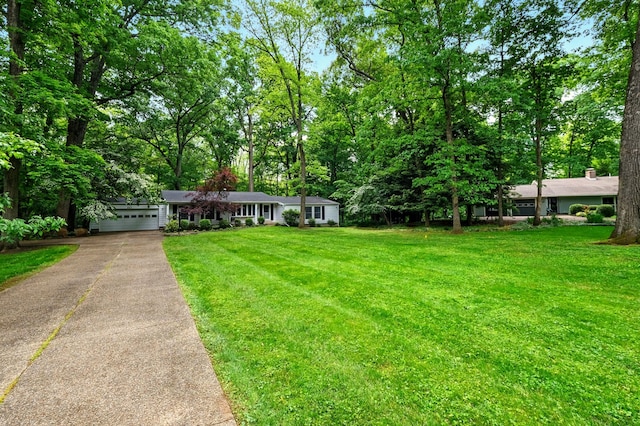 213 Kokosing Dr, Gambier, OH 43022 - view of front facade featuring driveway, an attached garage, and a front lawn