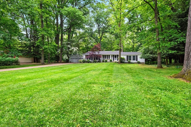 213 Kokosing Dr, Gambier, OH 43022 - view of front of home with an attached garage, driveway, and a front yard
