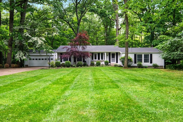 213 Kokosing Dr, Gambier, OH 43022 - ranch-style home with a garage, driveway, a front yard, and view of scattered trees