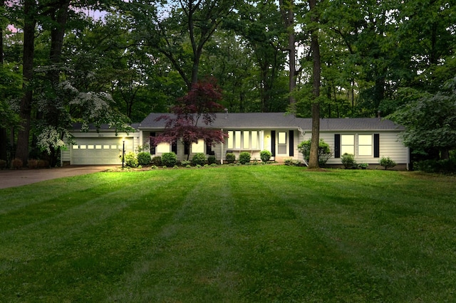 213 Kokosing Dr, Gambier, OH 43022 - ranch-style home featuring driveway, an attached garage, and a front lawn