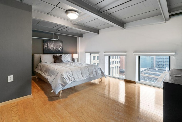 110 N 3rd St Unit 709, Columbus, OH 43215 - bedroom featuring beamed ceiling, access to outside, wood finished floors, and baseboards