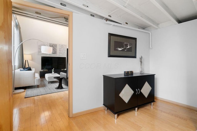110 N 3rd St Unit 709, Columbus, OH 43215 - hallway featuring light wood-style floors, baseboards, and beamed ceiling
