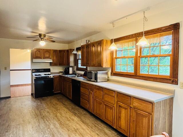 91 Bridle Path Ln, Granville, OH 43023 - kitchen featuring stove, under cabinet range hood, dishwasher, and plenty of natural light