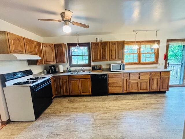 91 Bridle Path Ln, Granville, OH 43023 - kitchen featuring dishwasher, range with gas cooktop, under cabinet range hood, stainless steel microwave, and brown cabinetry