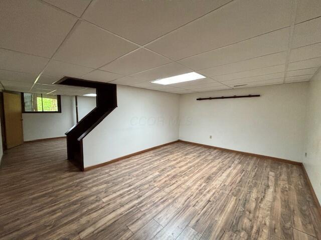 91 Bridle Path Ln, Granville, OH 43023 - below grade area with wood finished floors, a drop ceiling, and baseboards