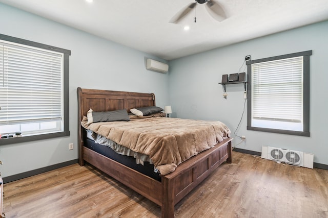 17994 Claypool Rd SE, Newark, OH 43056 - bedroom with a wall mounted air conditioner, wood finished floors, baseboards, ceiling fan, and recessed lighting