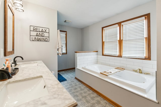 17994 Claypool Rd SE, Newark, OH 43056 - full bathroom featuring double vanity, a garden tub, and baseboards