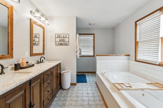 17994 Claypool Rd SE, Newark, OH 43056 - full bathroom with double vanity, a whirlpool tub, baseboards, and tile patterned floors