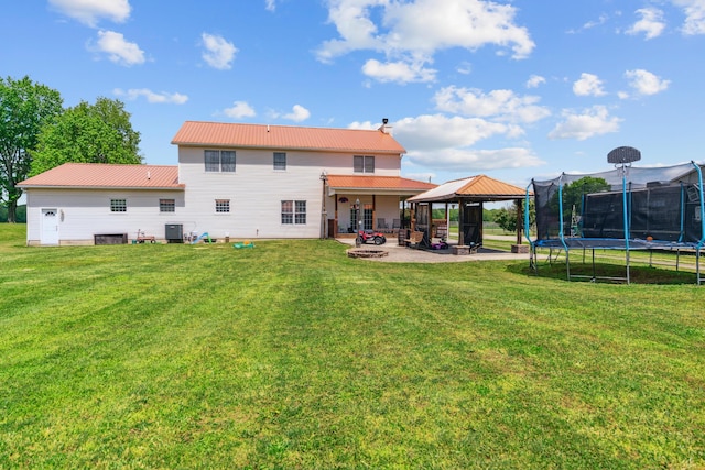 17994 Claypool Rd SE, Newark, OH 43056 - rear view of property featuring a gazebo, a trampoline, a patio area, and a yard