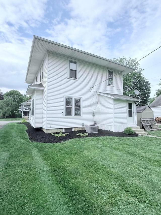 84 E 5th St, London, OH 43140 - back of property with a yard, central AC unit, and entry steps
