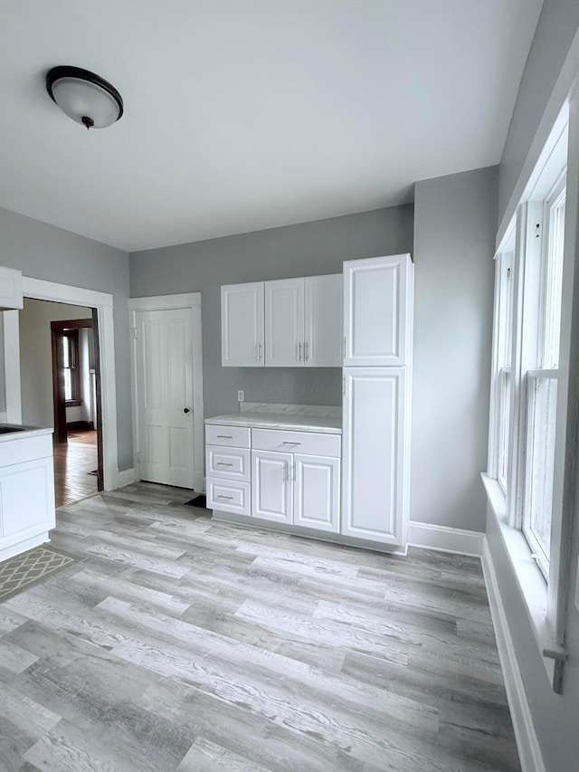 84 E 5th St, London, OH 43140 - kitchen featuring white cabinetry, baseboards, and light wood-style flooring