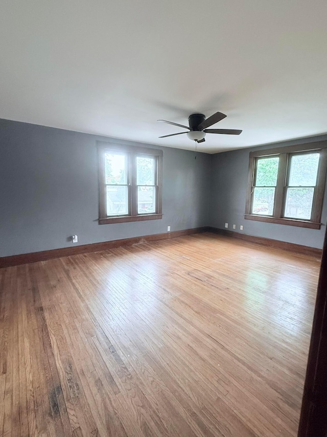84 E 5th St, London, OH 43140 - empty room with light wood finished floors, plenty of natural light, ceiling fan, and baseboards