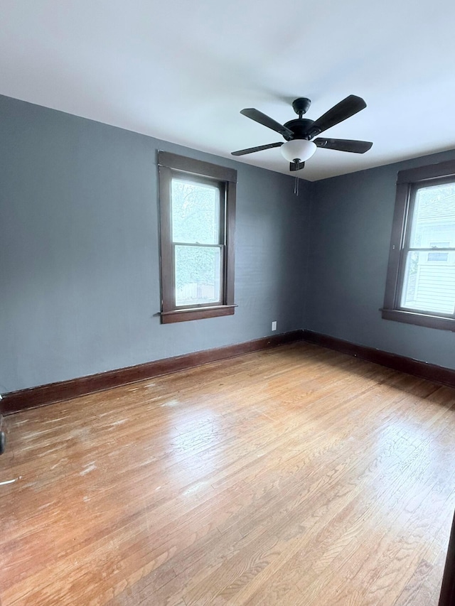 84 E 5th St, London, OH 43140 - unfurnished room featuring wood finished floors, baseboards, and a ceiling fan