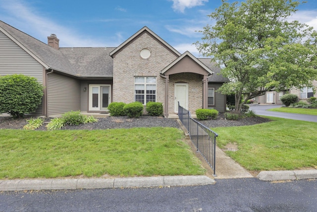 7706 Redman Ln, Reynoldsburg, OH 43068 - view of front of house featuring a front lawn, brick siding, and roof with shingles