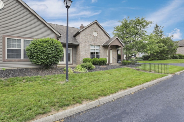 7706 Redman Ln, Reynoldsburg, OH 43068 - view of front facade with brick siding, a chimney, and a shingled roof