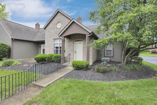 7706 Redman Ln, Reynoldsburg, OH 43068 - view of front facade featuring a chimney, brick siding, and a shingled roof