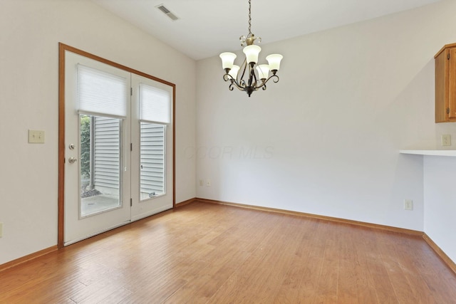 7706 Redman Ln, Reynoldsburg, OH 43068 - unfurnished dining area featuring a chandelier, light wood finished floors, and baseboards