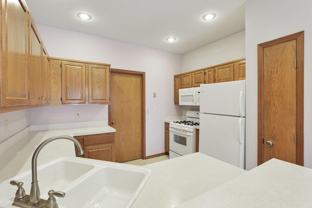 7706 Redman Ln, Reynoldsburg, OH 43068 - kitchen featuring white appliances, a sink, light countertops, brown cabinets, and recessed lighting