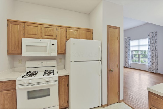 7706 Redman Ln, Reynoldsburg, OH 43068 - kitchen featuring white appliances, light countertops, and brown cabinetry