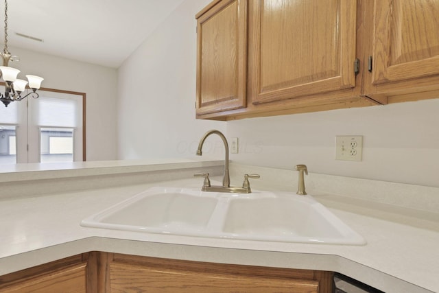 7706 Redman Ln, Reynoldsburg, OH 43068 - kitchen featuring a sink, light countertops, a chandelier, and pendant lighting
