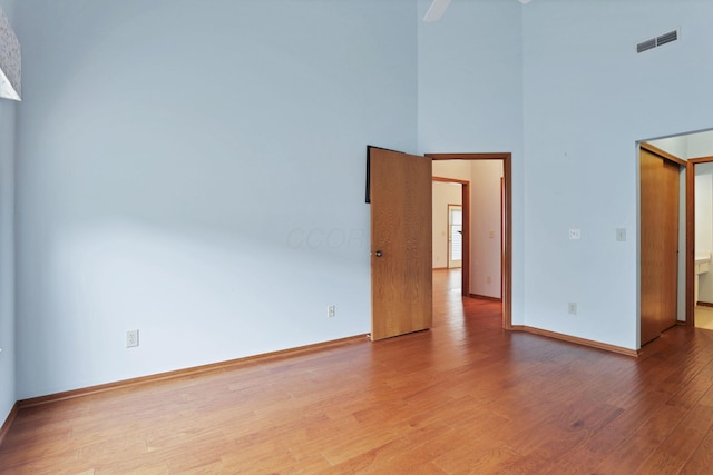 7706 Redman Ln, Reynoldsburg, OH 43068 - spare room with wood finished floors, baseboards, a high ceiling, and ceiling fan