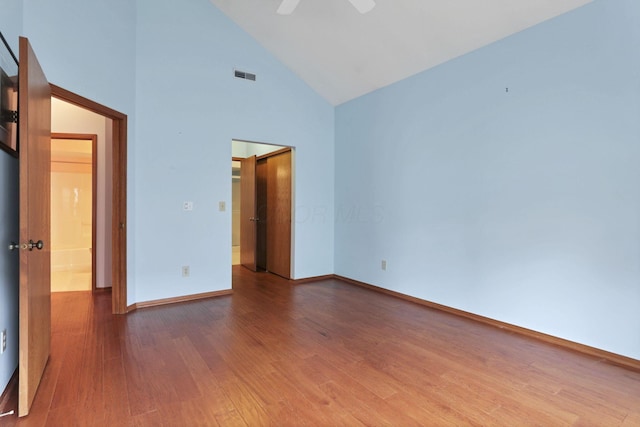 7706 Redman Ln, Reynoldsburg, OH 43068 - spare room with wood finished floors, high vaulted ceiling, baseboards, and ceiling fan