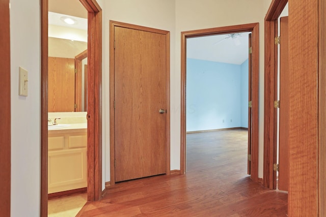 7706 Redman Ln, Reynoldsburg, OH 43068 - corridor featuring wood finished floors, a sink, and baseboards