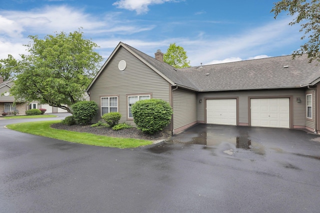 7706 Redman Ln, Reynoldsburg, OH 43068 - view of front facade with driveway, a garage, a chimney, and roof with shingles