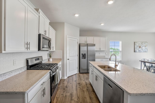 1002 Leslie Dr, Plain City, OH 43064 - kitchen featuring stainless steel appliances, a sink, white cabinetry, dark wood-style floors, and recessed lighting
